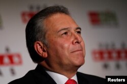 Retired general Oscar Naranjo, former head of the National Police of Colombia, reacts during a news conference in Mexico City, Mexico, June 14, 2012.