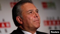 FILE - Retired general Oscar Naranjo, former head of the National Police of Colombia, reacts during a news conference in Mexico City, Mexico, June 14, 2012. 