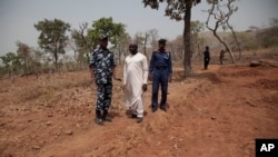 Security officers stand guard at the scene where a German archaeologists and his associate were kidnapped in Janjala Village, Nigeria, Feb. 24, 2017. 