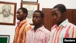 Suspected members of the Abu Mohammed-led faction of the radical Islamic sect Boko Haram , Bashir Ibrhim (L), Ibrahim Habibu (C) and Gambo Maiborodi, are presented to the media while awaiting official charges for alleged involvement in the kidnap and kill