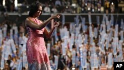 First Lady Michelle Obama waves after addressing the Democratic National Convention in Charlotte, North Carolina, September 3, 2012. 