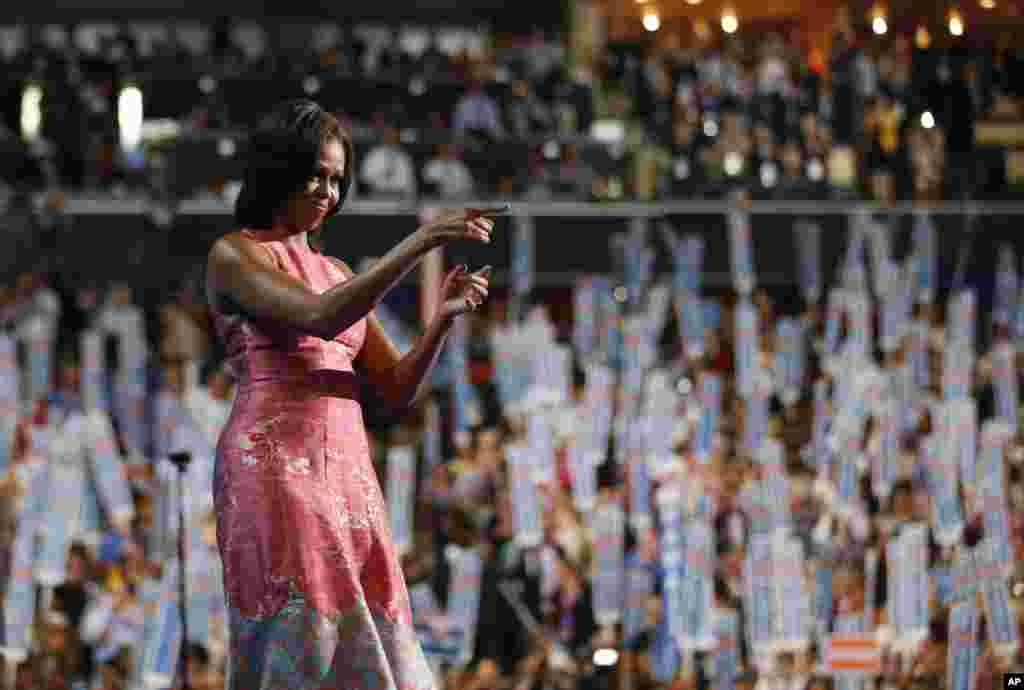 Ibu Negara Michelle Obama melambaikan tangan setelah pidatonya yang mengesankan pada konvensi.