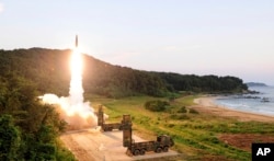 In this photo provided by South Korea Defense Ministry, Hyunmoo II ballistic missile is fired during an exercise at an undisclosed location in South Korea, Sept. 4, 2017.