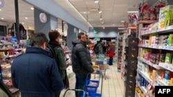 Customers line up to buy food and essential products in a Milan supermarket March 7, 2020, as Italy prepared to quarantine more than 15 million people around Milan and Venice for nearly a month to halt the spread of the new coronavirus.