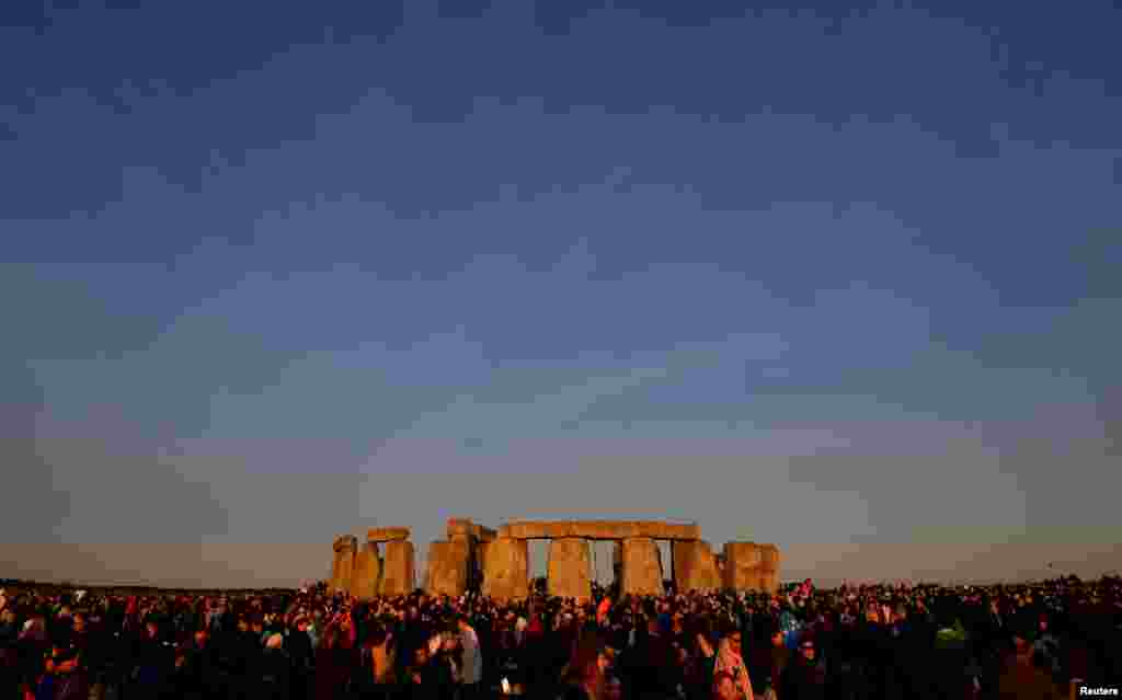 Revellers welcome in the Summer Solstice at Stonehenge stone circle in southwest Britain.