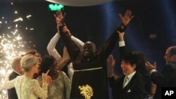 Kenyan teacher Peter Tabichi, center, reacts after winning the $1 million Global Teacher Prize in Dubai, United Arab Emirates, Sunday, March 24, 2019. 