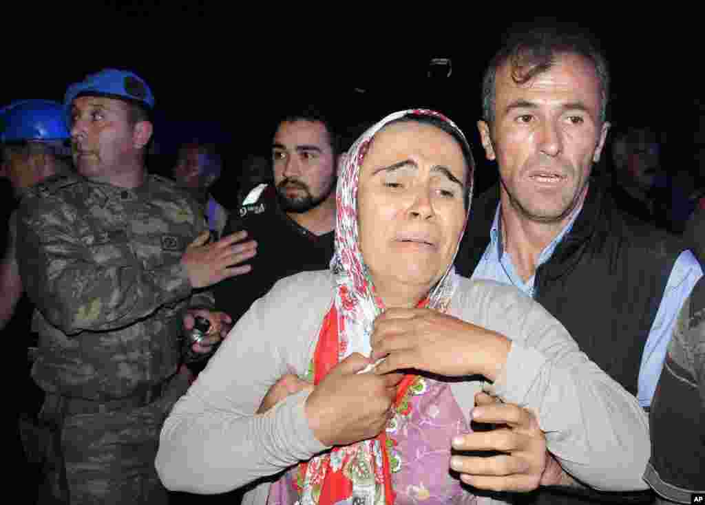 Family members gather near the mine after a deadly explosion and fire at a coal mine in Soma, western Turkey, May 13, 2014. 