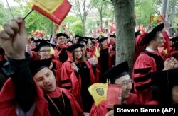 Harvard University students graduating with masters degrees in philosophy celebrate during Harvard University's commencement exercises, Thursday, May 30, 2019, on the schools campus in Cambridge, Massachusetts.