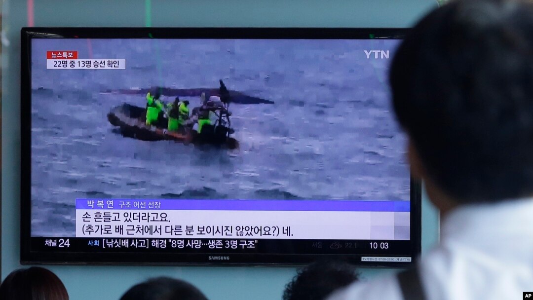 Orang-orang menonton berita penjaga pantai Korea Selatan mencari penumpang yang hilang setelah sebuah kapal nelayan tenggelam di pulau resor Jeju, di stasiun kereta api Seoul di Seoul, Korea Selatan, Minggu, 6 September 2015
