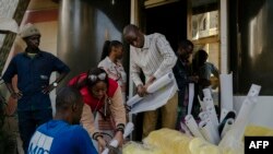 FILE —Employers and activists prepare posters for presidential candidate and founder of the Alternative pour la relève citoyenne (ARC) party, Anta Babacar Ngom in the Hann Mariste district of Dakar on March 11, 2024.