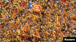 FILE - Catalan pro-independence demonstrators attend a rally at Catalunya square in Barcelona, Spain, Oct. 19, 2014. 