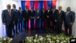 FILE - Members of the Haiti Transitional Council pose for a group photo during an installation ceremony, in Port-au-Prince, Haiti, April 25, 2024.