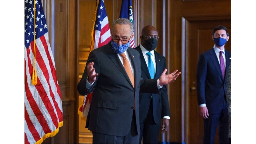 On the first full day of the Democratic majority in the Senate, Majority Leader Chuck Schumer, D-N.Y., left, is joined by Sen. Raphael Warnock, D-Ga., center, and Sen. Jon Ossoff, D-Ga., during a press event at the Capitol, Jan. 21, 2021.