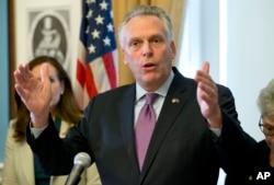 FILE - Virginia Gov. Terry McAuliffe gestures during a news conference at the Capitol in Richmond, Va., Jan. 10, 2017.