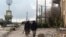 Rebel fighters walk around al-Hamidiyeh base, one of two military posts they took control of from forces loyal to Syria's President Bashar al-Assad in the northwestern province of Idlib, Dec. 15, 2014. 