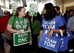 Supporters of Rep. Keith Ellison of Minnesota and former Secretary of Labor Tom Perez, candidates for Democratic National Committee chairman, speak to each other during a Democratic National Committee forum in Baltimore, Maryland, Feb. 11, 2017.
