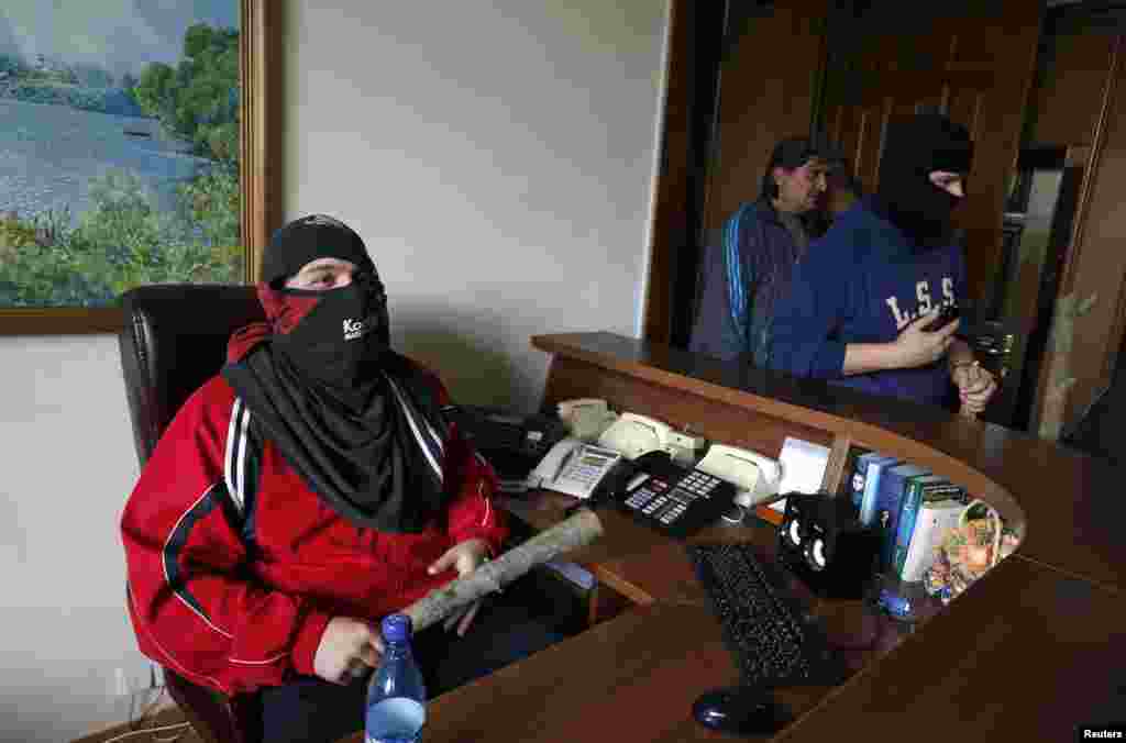 Pro-Russian activists are seen inside the regional government headquarters in Luhansk, eastern Ukraine, April 29, 2014. Hundreds of pro-Russian separatists stormed the headquarters on Tuesday, unopposed by police, and the Ukrainian government said they al