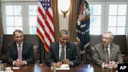 President Barack Obama sits with House Speaker John Boehner of Ohio (L), and Senate Majority Leader Harry Reid of Nevada, as he met with Republican and Democratic leaders regarding the debt ceiling, in the Cabinet Room of the White House in Washington, DC