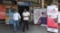 FILE - People walk past banners inviting students to study in Canada and other places abroad at a market in Amritsar, in the northern Indian state of Punjab, Oct. 15, 2024.