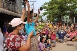 This handout photo taken and released by Dawei Watch on Apr.1, 2021 shows protesters making the three-finger salute during a demonstration against the military coup in Dawei. (Photo by Handout / Dawei Watch / AFP)