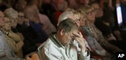 People watch a taped interview of Russell Henderson, who is serving two consecutive life sentences for the murder of Matthew Shepard, during a community forum in Laramie, Wyo., Oct. 9, 2018. About 200 people attended the forum questioning the prevailing view that Shepard was murdered because of his sexual orientation.