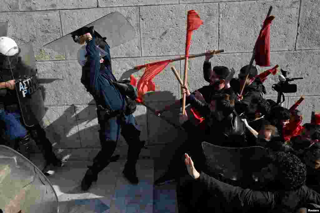 Protesters clash with riot police during a demonstration outside the parliament building against planned government reforms in Athens, Greece.