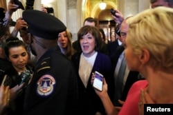 U.S. Sen. Susan Collins, R-Maine, leaves the Senate floor surrounded by Capitol police and reporters at the U.S. Capitol in Washington, Oct. 6, 2018.