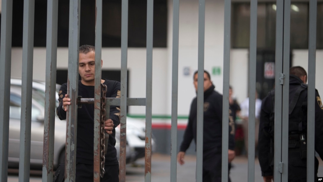 A security agent closes a gate outside the federal building housing the offices of the national immigration service, where Ethan Couch was seen departing in an immigration van shortly after, in Guadalajara, Mexico, Wednesday, Dec. 30, 2015.