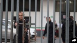 A security agent closes a gate outside the federal building housing the offices of the national immigration service, where Ethan Couch was seen departing in an immigration van shortly after, in Guadalajara, Mexico, Wednesday, Dec. 30, 2015.