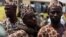 Mahajjata na tsaye a wani sansanin alhazai su na jira a yi mu su gwajin cutar Ebola kafin su shiga jirgin saman zuwa Saudiyya, a ranar goma sha takwas ga watan satumba shekarar dubu biyu da goma sha hudu. 