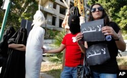 FILE - Activists from a civil organization reenact an execution scene in front of the Saudi Arabia Embassy in Beirut, Lebanon, April 1 2010.
