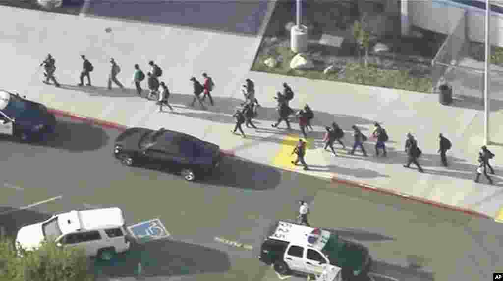 Students are lead out of Saugus High School after reports of a shooting in Santa Clarita, California. (Credit: KTTV-TV)