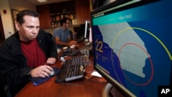 FILE - In this Sept. 13, 2011 file photo, Anthony Guarino Jr., a seismic analyst at the California Institute of Technology, demonstrates an early earthquake warning system in Pasadena, Calif. (AP Photo/Reed Saxon, File)