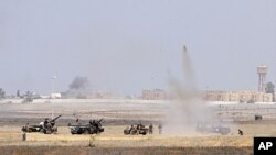 Anti-Gaddafi fighters push forward towards the center of Sirte during heavy fighting, October 1, 2011.