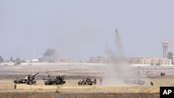 Anti-Gaddafi fighters push forward towards the center of Sirte during heavy fighting, October 1, 2011.