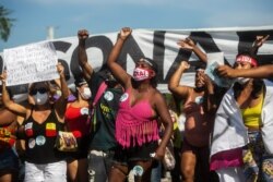 FILE - Demonstrators shouts slogans during a protest against the government's response in combating COVID-19, demanding the impeachment of President Jair Bolsonaro, in Rio de Janeiro, May 29, 2021.