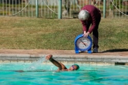 onata Katai is seen during a swimming practice session in Harare, Zimbabwe, Saturday, July 10, 2021. The southern African nation is sending the black swimmer to the Olympics, the first from her country to the Games. (AP)