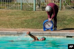 onata Katai is seen during a swimming practice session in Harare, Zimbabwe, Saturday, July 10, 2021. The southern African nation is sending the black swimmer to the Olympics, the first from her country to the Games. (AP)