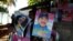 A man holds campaign posters in support of Nicaragua's President Daniel Ortega and vice presidential candidate first lady Rosario Murillo in Managua, Oct. 27, 2016.
