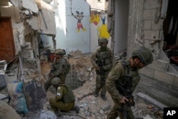 FILE - Israeli soldiers stand at the entrance of a tunnel where the military says six Israeli hostages were recently killed by Hamas militants, in the southern Gaza Strip, Sept. 13, 2024.