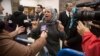 Suha Abu Khdeir, center, mother of Mohammed Abu Khdeir, a 16-year-old Palestinian murdered in 2014, speaks to reporters at a court during the sentencing of two Israelis accused of his murder, in Jerusalem, Feb. 4, 2016. 