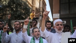 Palestinian Hamas supporters take part in a protest against Israel's plan to annex parts of the occupied West Bank, in Khan Yunis in the southern Gaza Strip on June 26, 2020.