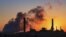 FILE - In this July 27, 2018, file photo, the Dave Johnson coal-fired power plant is silhouetted against the morning sun in Glenrock, Wyo. 