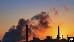 FILE - In this July 27, 2018, file photo, the Dave Johnson coal-fired power plant is silhouetted against the morning sun in Glenrock, Wyo. More than 300 businesses and investors are calling on the Biden administration to set an ambitious climate change go