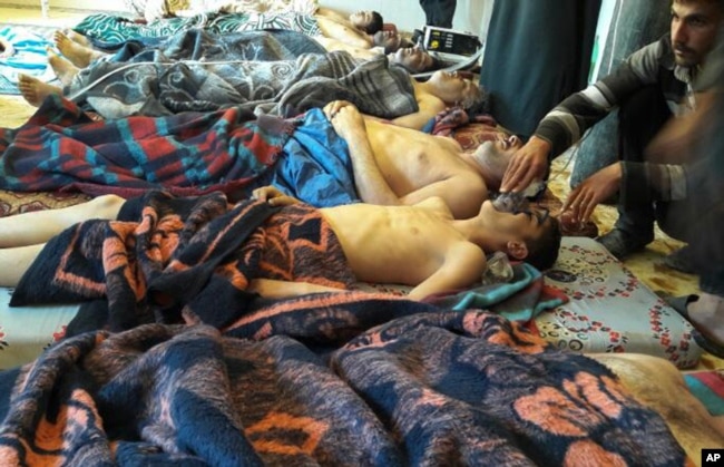 FILE - Victims of a suspected chemical weapons attack lie on the ground in Khan Sheikhoun, Idlib province, Syria, April 4, 2017.