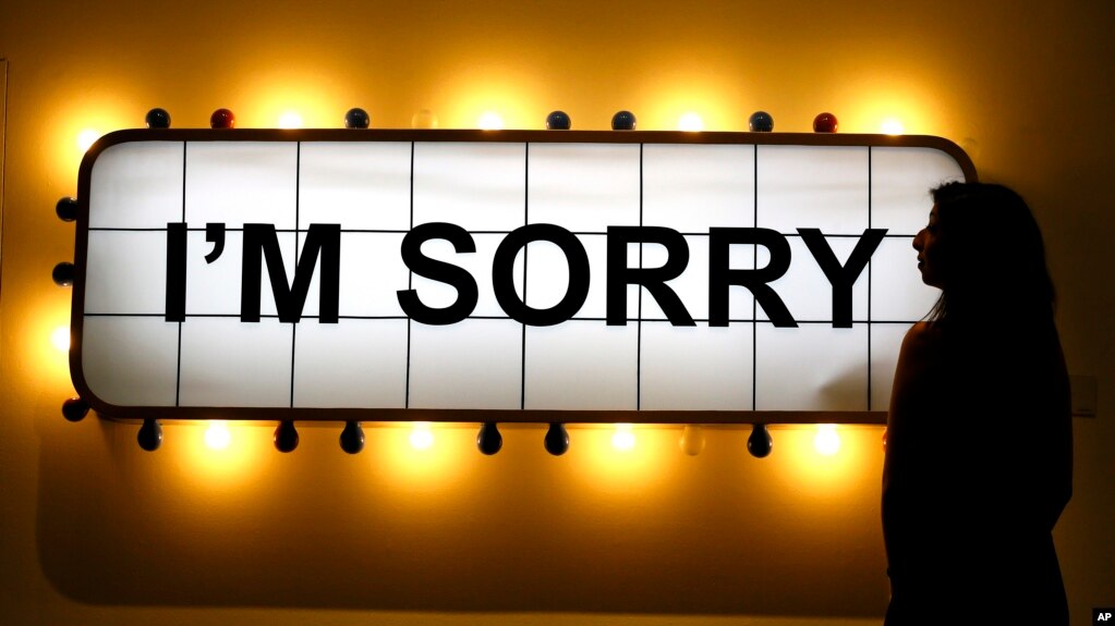 A Sotheby's employee looks at an artwork by Adel Abidin called 'I'm Sorry' at Sotheby's auction rooms in London, Friday, April 15, 2016. New research suggests that saying sorry when you reject someone in a social situation does more harm than good. (AP Photo/Kirsty Wigglesworth)