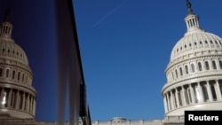 FILE - The U.S. Capitol dome and its reflection are seen in Washington, Jan. 15, 2020.