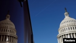 FILE - The U.S. Capitol dome and its reflection are seen in Washington, Jan. 15, 2020.