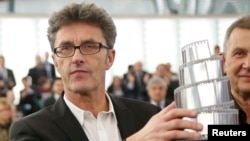 Polish director Pawel Pawlikowski poses with his trophy after he was awarded the Lux cinema prize of the European Parliament for his film "Ida' during a ceremony at the European Parliament in Strasbourg, France, Dec. 17, 2014. 
