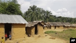 Children stand at there house outside the small village of Walikale, Congo. Hundreds of woman and children have been victims of rape and murder in Congo, by rebel troops.